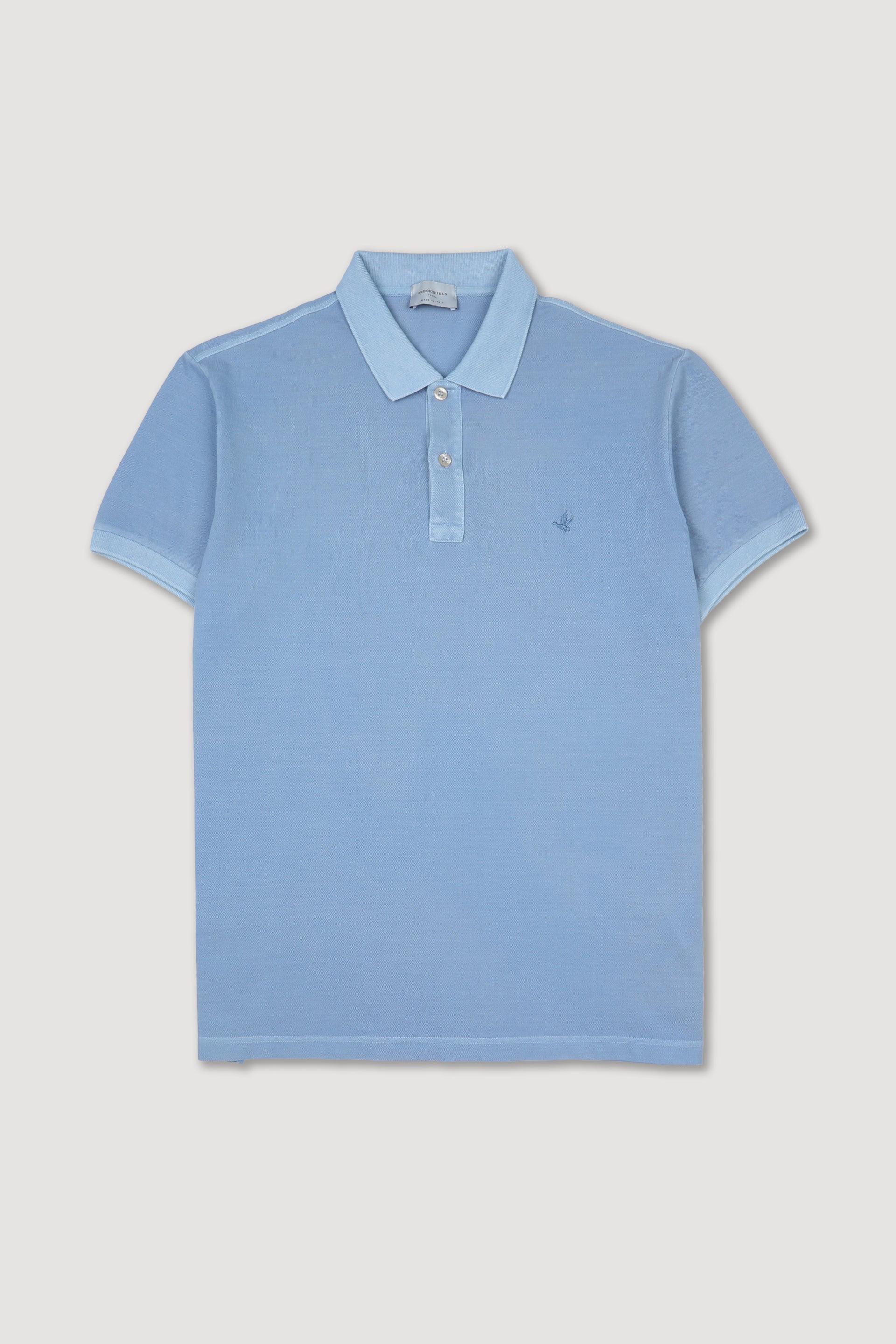 Polo in piquet di cotone, tintura effetto old. Logo ricamato al cuore. Azzurro - Iris