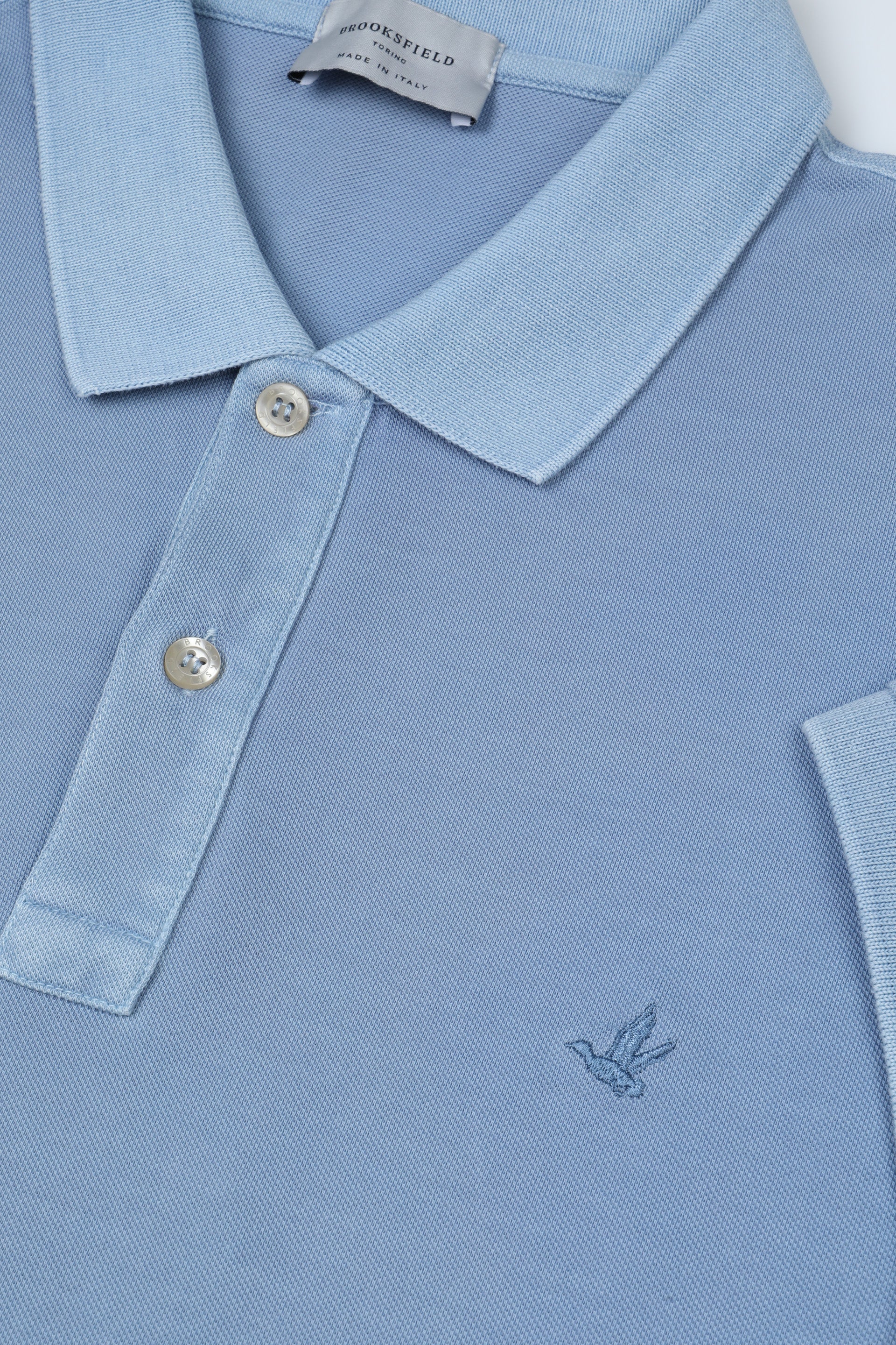 Polo in piquet di cotone, tintura effetto old. Logo ricamato al cuore. Azzurro - Iris