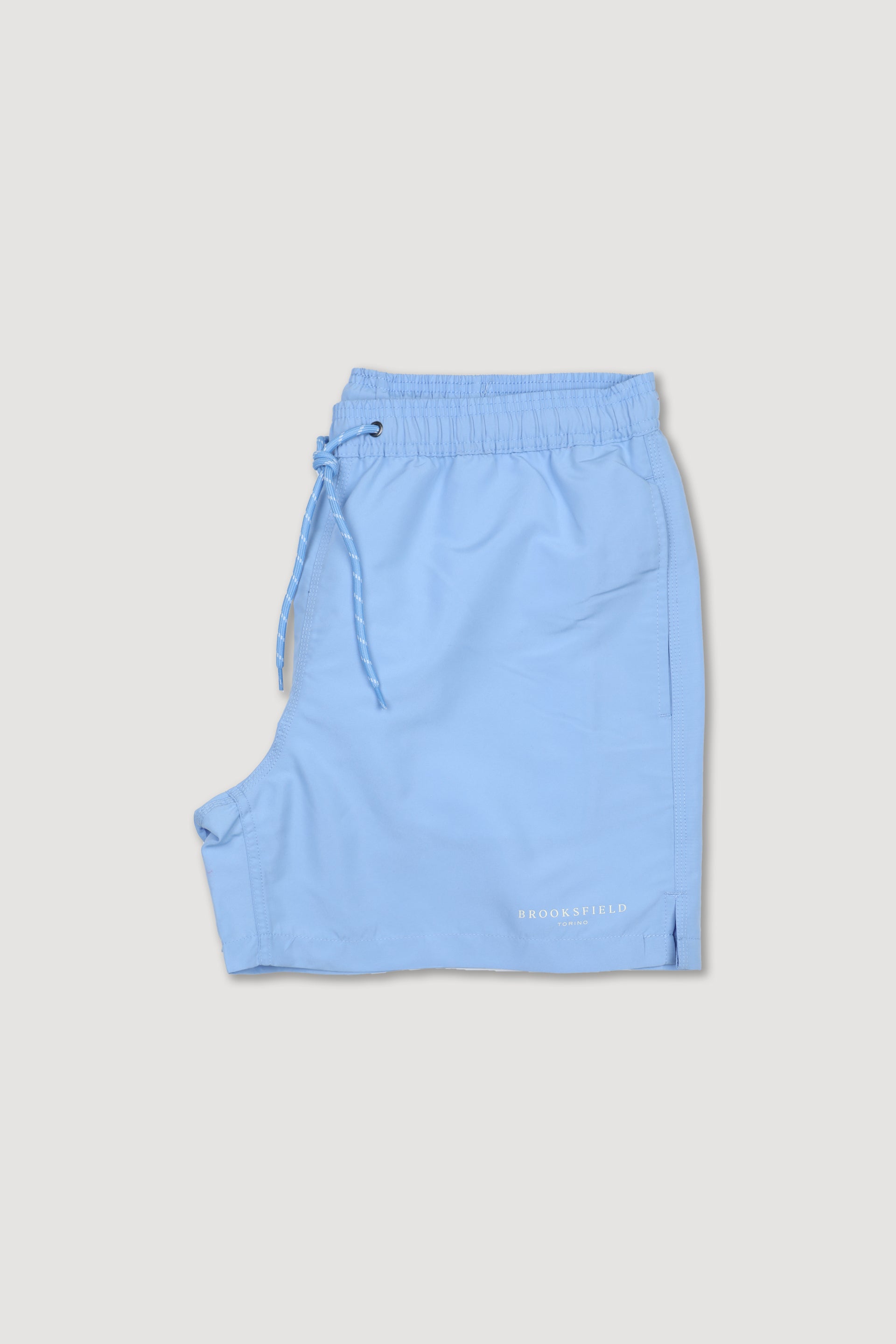 UOMO-BOXER MARE IN MICROFIBRA TINTA UNITA, TASCHE LATERALI, TASCHINO CON ALETTA APPLICATO DIETRO, ELASTICO E COULISSE IN VITA, STAMPA MARCHIO SU GAMBA - Sky blue